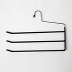 A black metal clothes hanger with three horizontal bars and a single hook, shown against a plain white background.