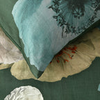 Close-up of a textured fabric with floral patterns and a pillow.
