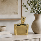 Design Republique Gold Body Abstract Statue Vase Large displayed on a light wood console with neutral books, framed artwork and a textured vase.