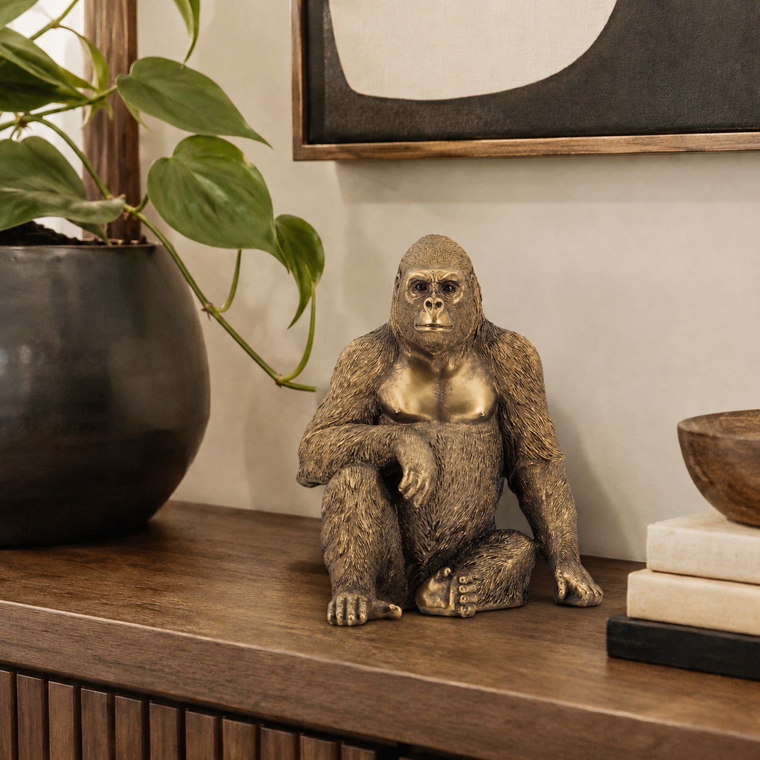 Design Republique Gorilla Decor in gold, styled on a console table with neutral décor and greenery.