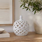 Gracious Living Ascot Braid Ceramic Jar with Lid in white, styled on a console with an open lattice design and decorative lidded top.