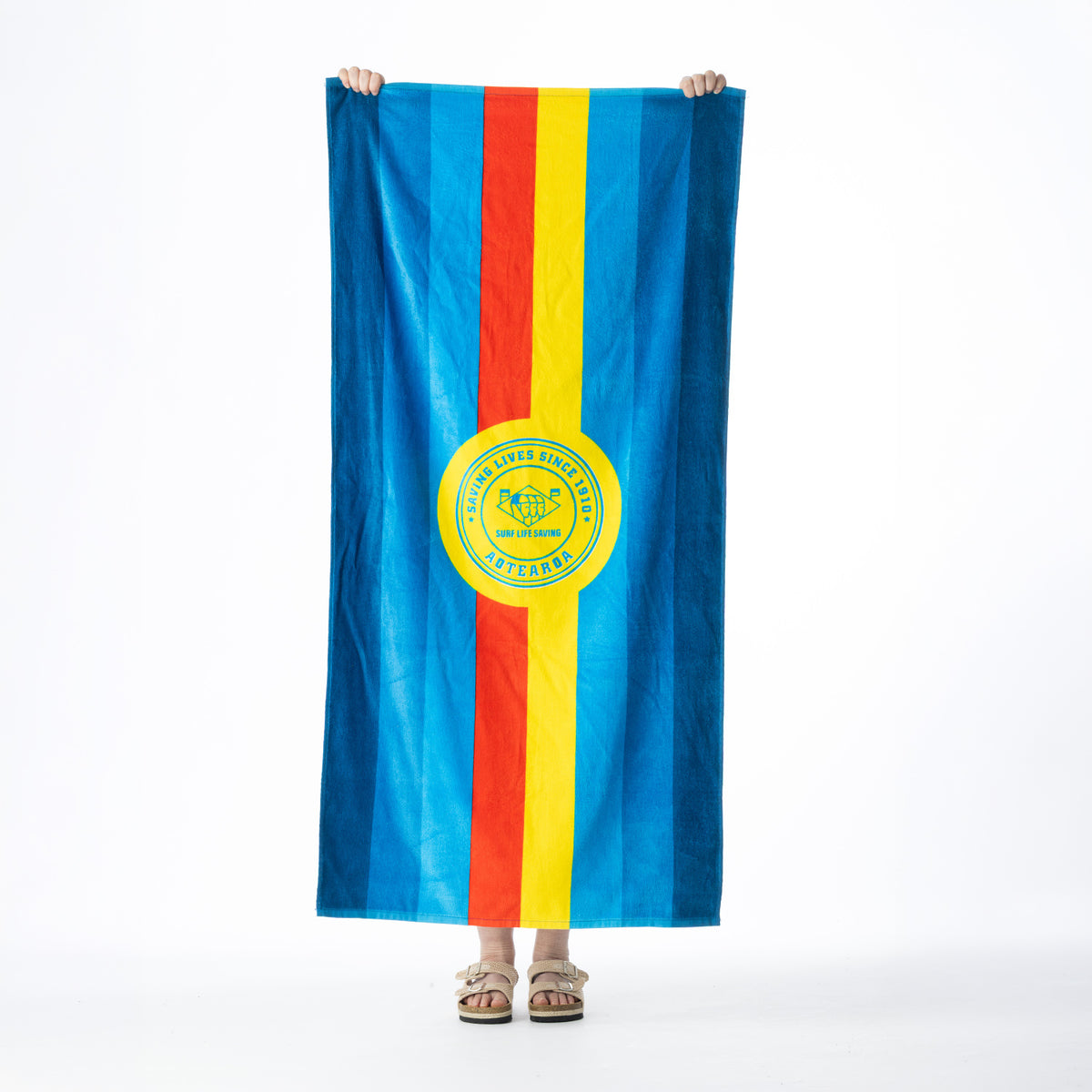 Multicoloured Surf Life Saving beach towel featuring bold blue, red and yellow stripes