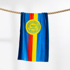 Blue, red and yellow Surf Life Saving beach towel hanging over a rope