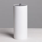 A sleek white freestanding toilet roll holder with a minimalist cylindrical design and brushed metal top detail provides stylish, convenient bathroom storage.