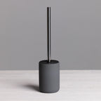A modern charcoal toilet brush with a minimalist cylindrical holder and brushed stainless steel handle brings sleek, contemporary style to any bathroom.