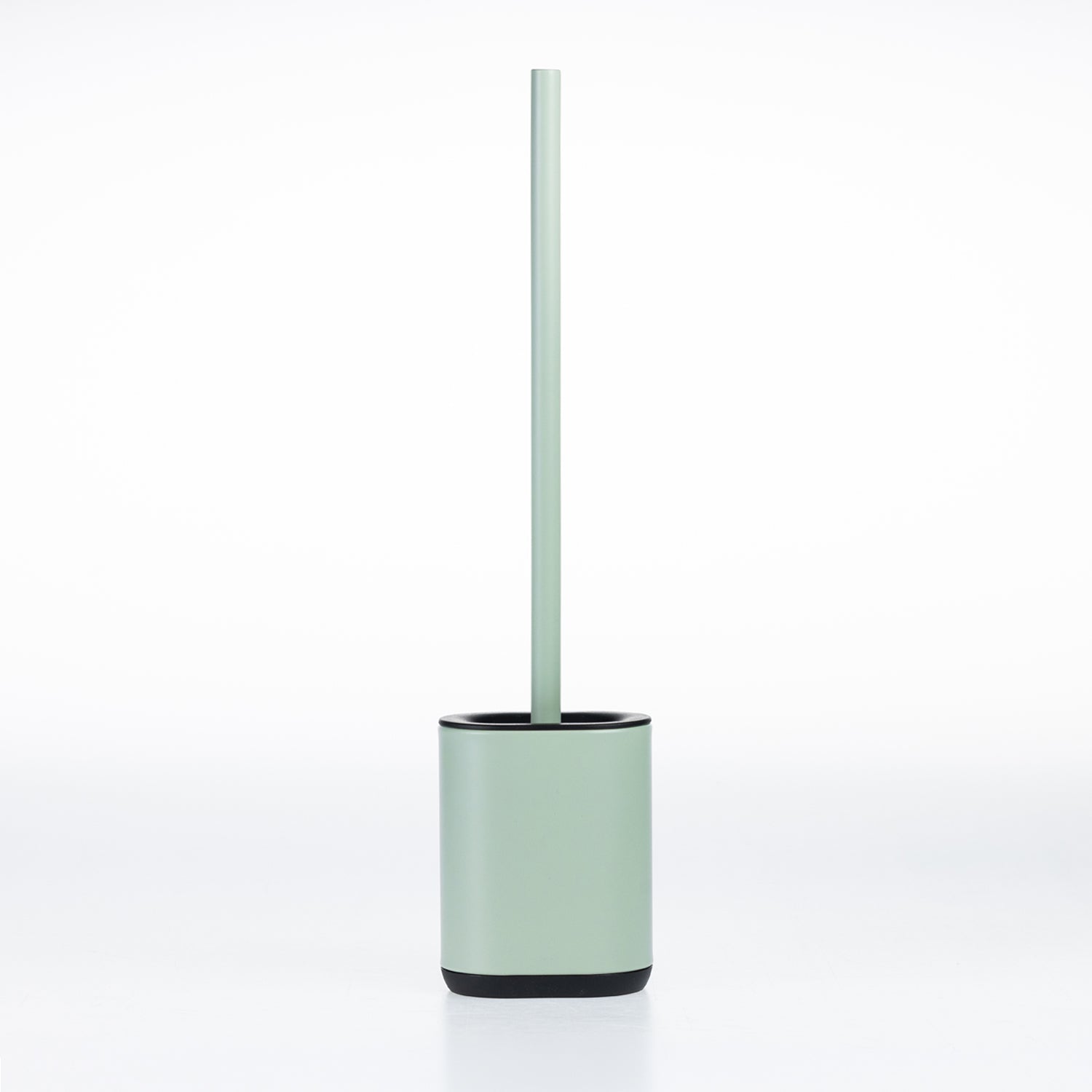A minimalist toilet brush with a pale sage green handle and base, accented by a black rim and bottom base, set against a seamless white background.