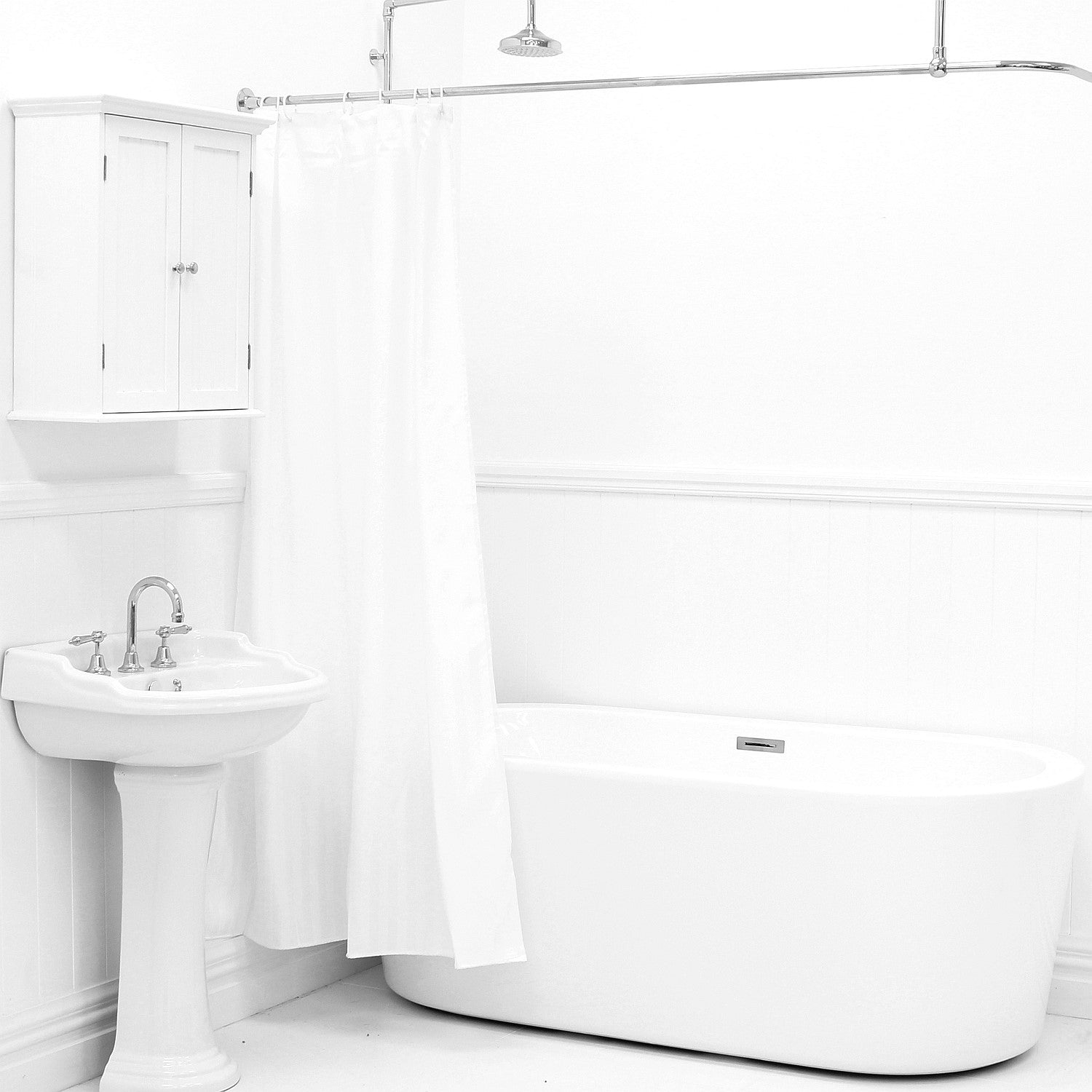 White shower curtain hanging beside a white bathtub and pedestal sink in a bright bathroom.