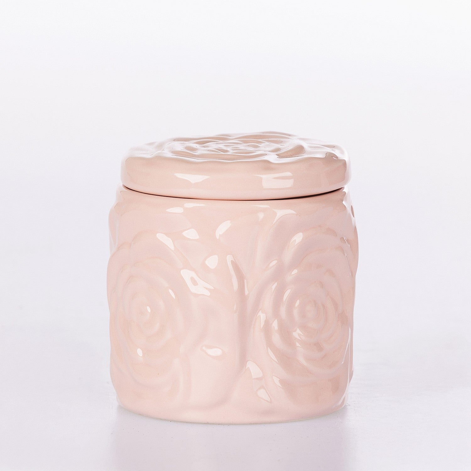Pink ceramic jar with decorative lid on a white background