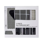Packaged Home Co. Jake five-piece black bathroom set displayed in a white retail box with a clear window showing the shower curtain, bathmat, soap dispenser, tumbler, soap dish, and silver shower rings.