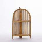 A natural wood corner shelving unit with an arched slatted design and two woven shelves is displayed against a clean white background.