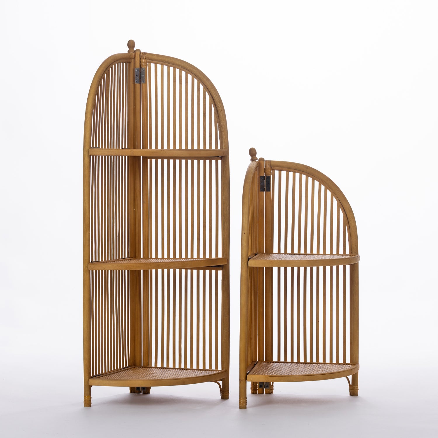 Two natural wood corner shelving units in coordinating tall and short sizes feature elegant arched slatted designs and woven shelves, offering timeless style for displaying décor in compact spaces.