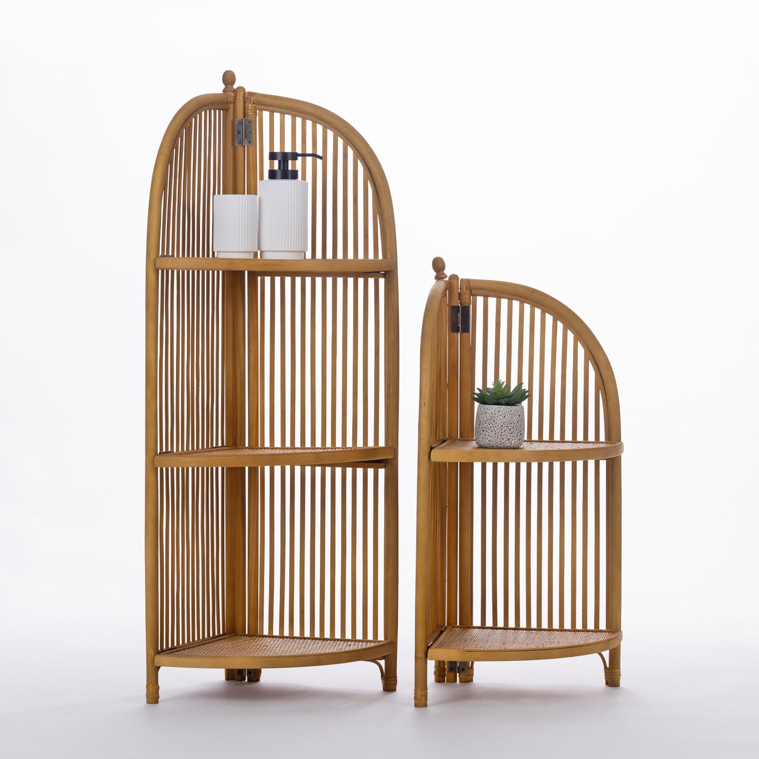 Two natural wood corner shelving units with arched slatted designs are displayed side by side, styled with simple decorative accessories to showcase their versatile storage and timeless appeal.