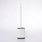 White toilet brush and holder with a black trim, featuring a slim handle and modern rectangular design on a white background.
