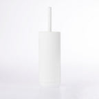 White soft touch toilet brush with a minimalist cylindrical holder on a white background.