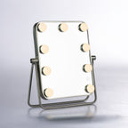 LED tabletop vanity mirror with illuminated globe lights, silver frame and adjustable stand.