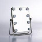 LED tabletop vanity mirror with nine globe lights, silver frame and adjustable stand.