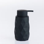 Black faceted soap dispenser with a matte pump, combining a contemporary geometric design with everyday functionality.