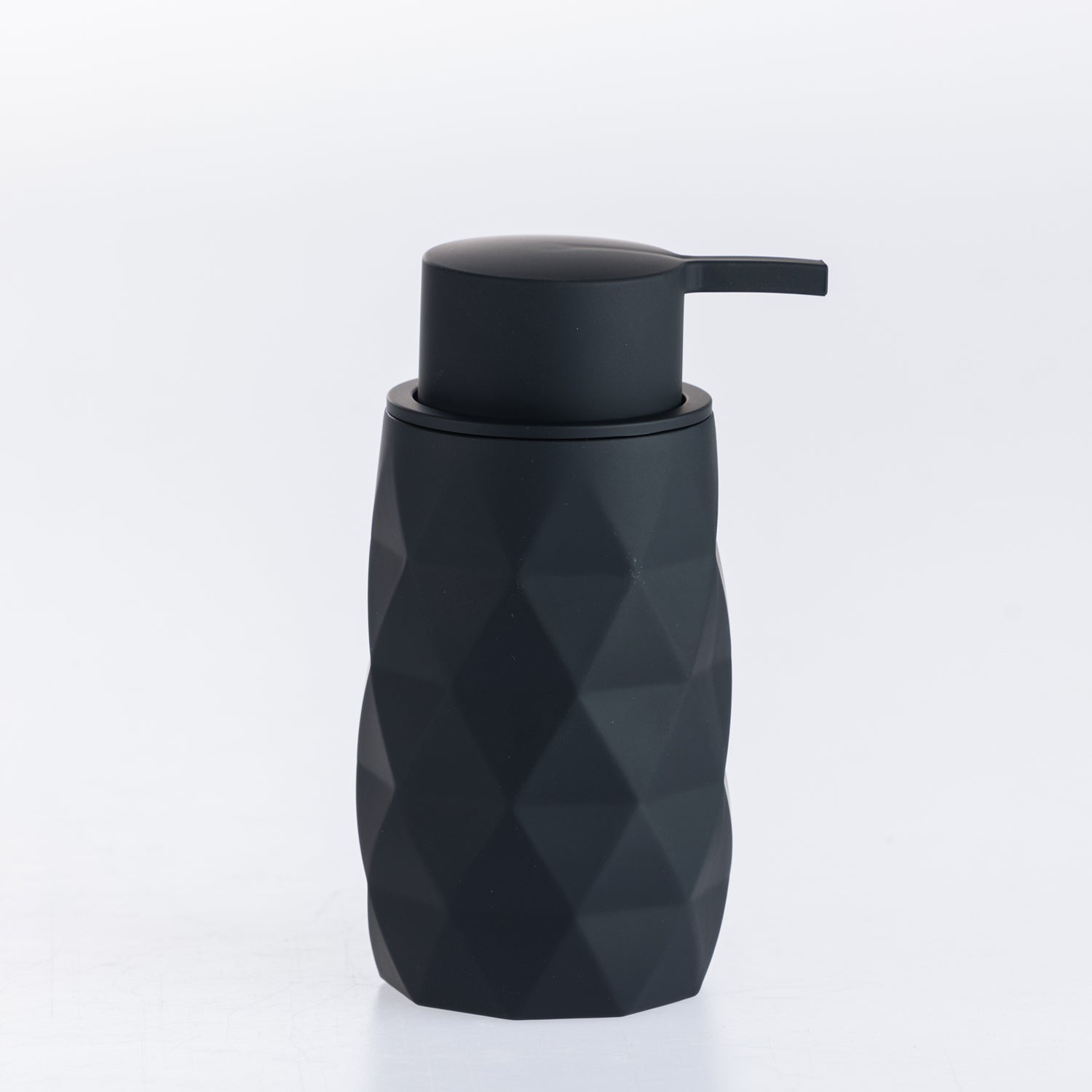 Black faceted soap dispenser with a matte pump, combining a contemporary geometric design with everyday functionality.