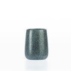 Charcoal speckled bathroom tumbler with a rounded stoneware-style design, ideal for holding toothbrushes and bathroom essentials.
