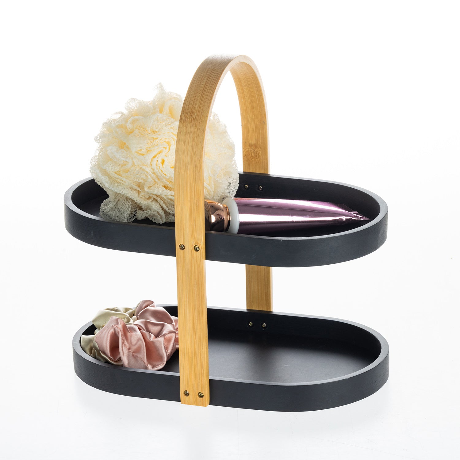 Black two-tier bathroom storage caddy with a bamboo carry handle, styled with a bath sponge, satin scrunchies and a cosmetic bottle.