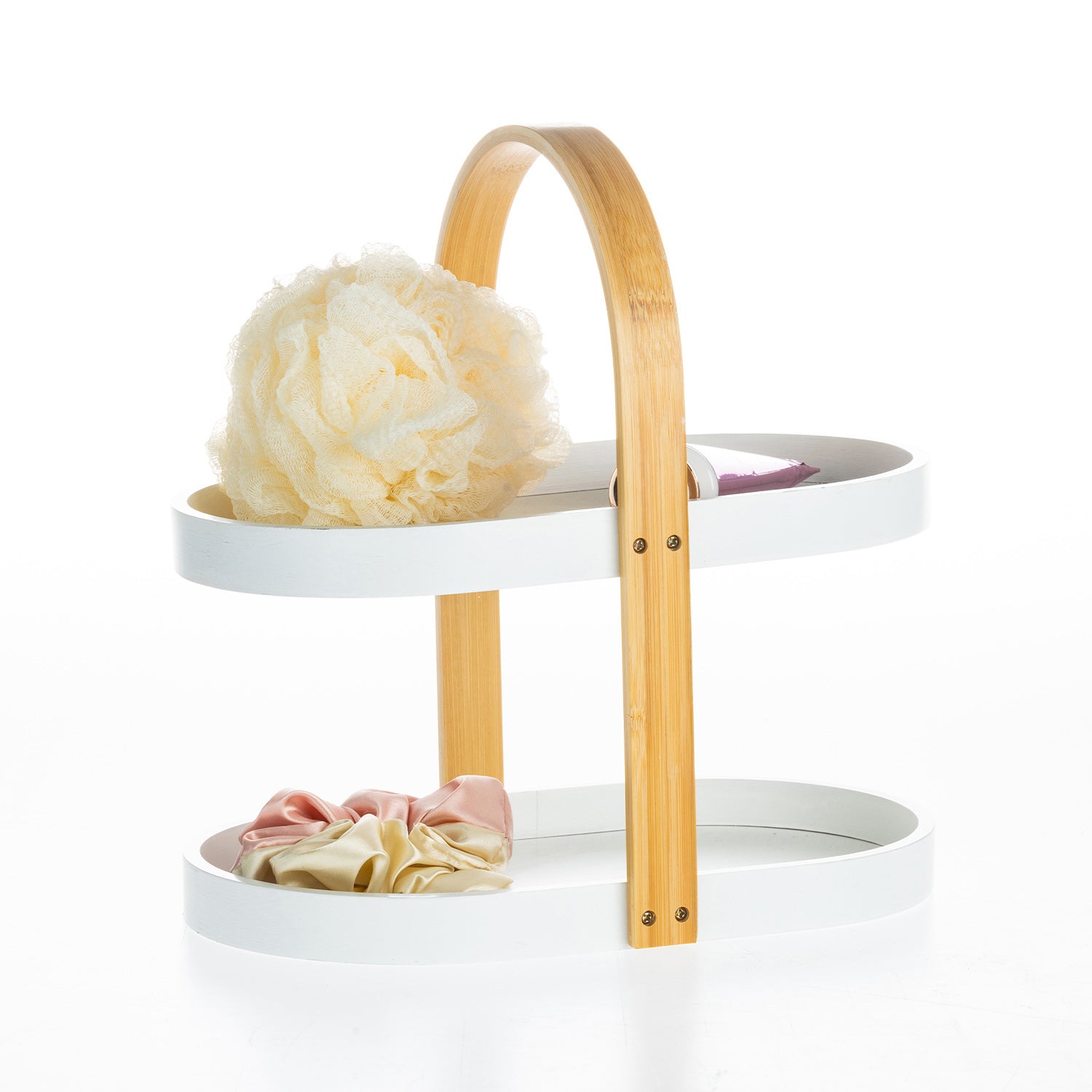 White two-tier bathroom storage caddy with a bamboo carry handle, styled with a bath sponge, satin scrunchies and a cosmetic bottle.