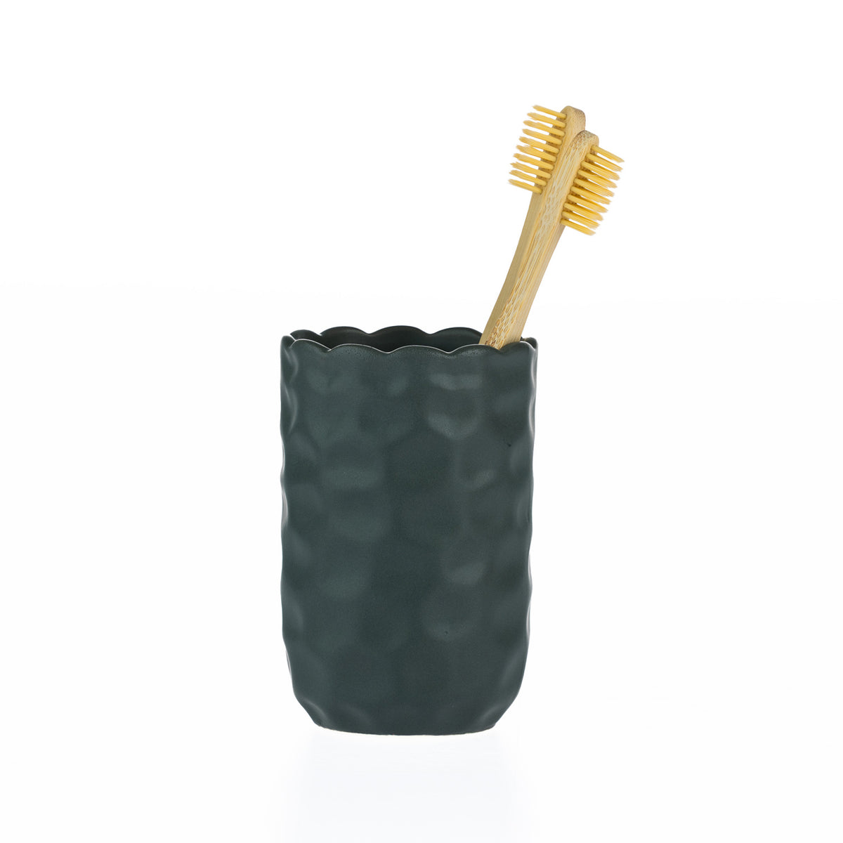 A matte forest green textured tumbler with a softly scalloped rim, styled with two bamboo toothbrushes.