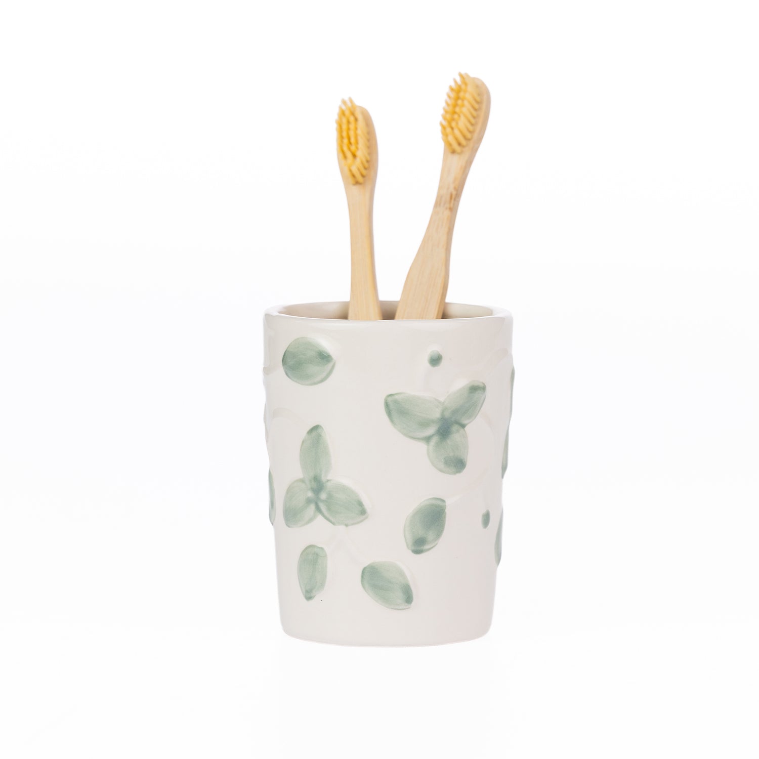 Ceramic Gracious Living Irina Floral Toothbrush Holder in Ivory with a soft green floral pattern, holding two natural bamboo toothbrushes.