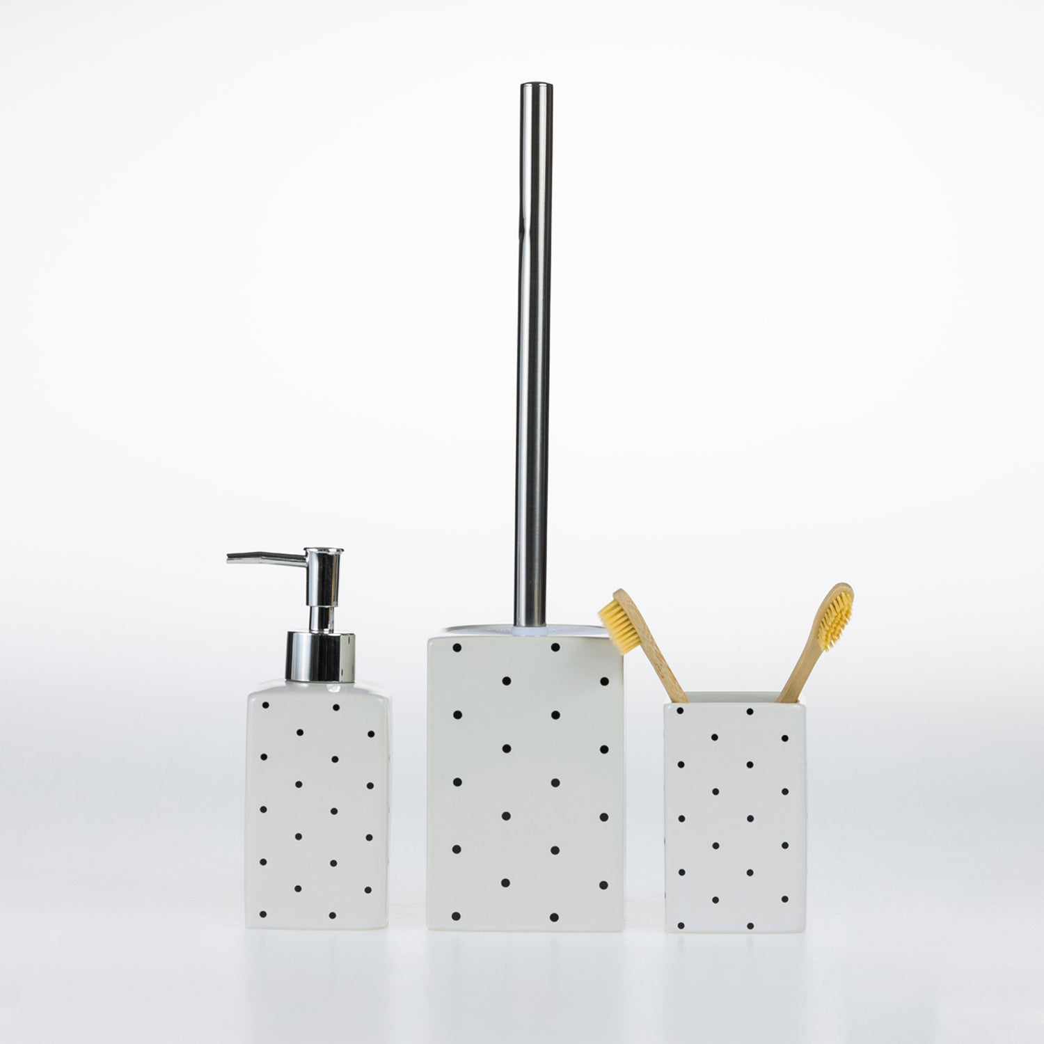 Design Republique Spotty Ceramic Bathroom Accessories in White, featuring a coordinating soap dispenser, toilet brush holder and tumbler with black spot detailing.