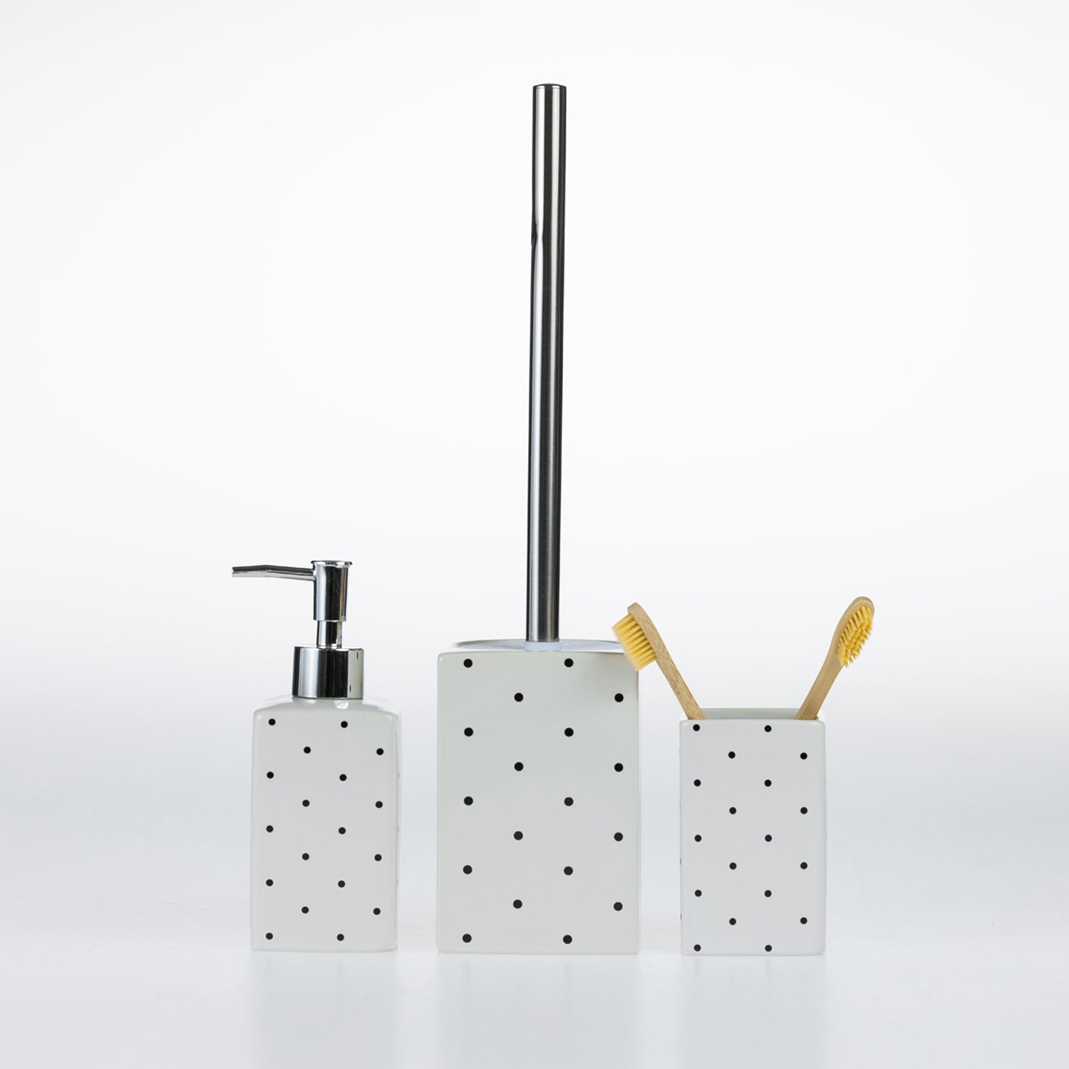 Design Republique Spotty Ceramic Bathroom Accessories in White, featuring a coordinating soap dispenser, toilet brush holder and tumbler with black spot detailing.