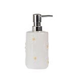 Marlo Daisy Ceramic Soap Dispenser in Ivory, featuring a glossy ceramic finish with raised white daisy flowers, yellow centres and a shiny silver pump.
