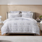 Bed with patterned bedding in a bedroom setting