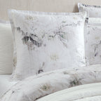 White floral bedding set with matching pillows and duvet cover, featuring a delicate gray and green watercolor-style floral print.