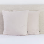 A pair of natural European pillowcases brings a subtle, elegant touch to a neatly styled bed.