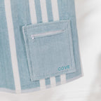 Close-up of the Seafoam Blue Cove Pocket Towel showing the matching zippered pocket, white stripe detailing and embroidered Cove logo.