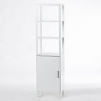 A tall white bathroom shelving unit with three open display shelves, a paneled cupboard, and a brushed metal handle offers a stylish combination of open and concealed storage.