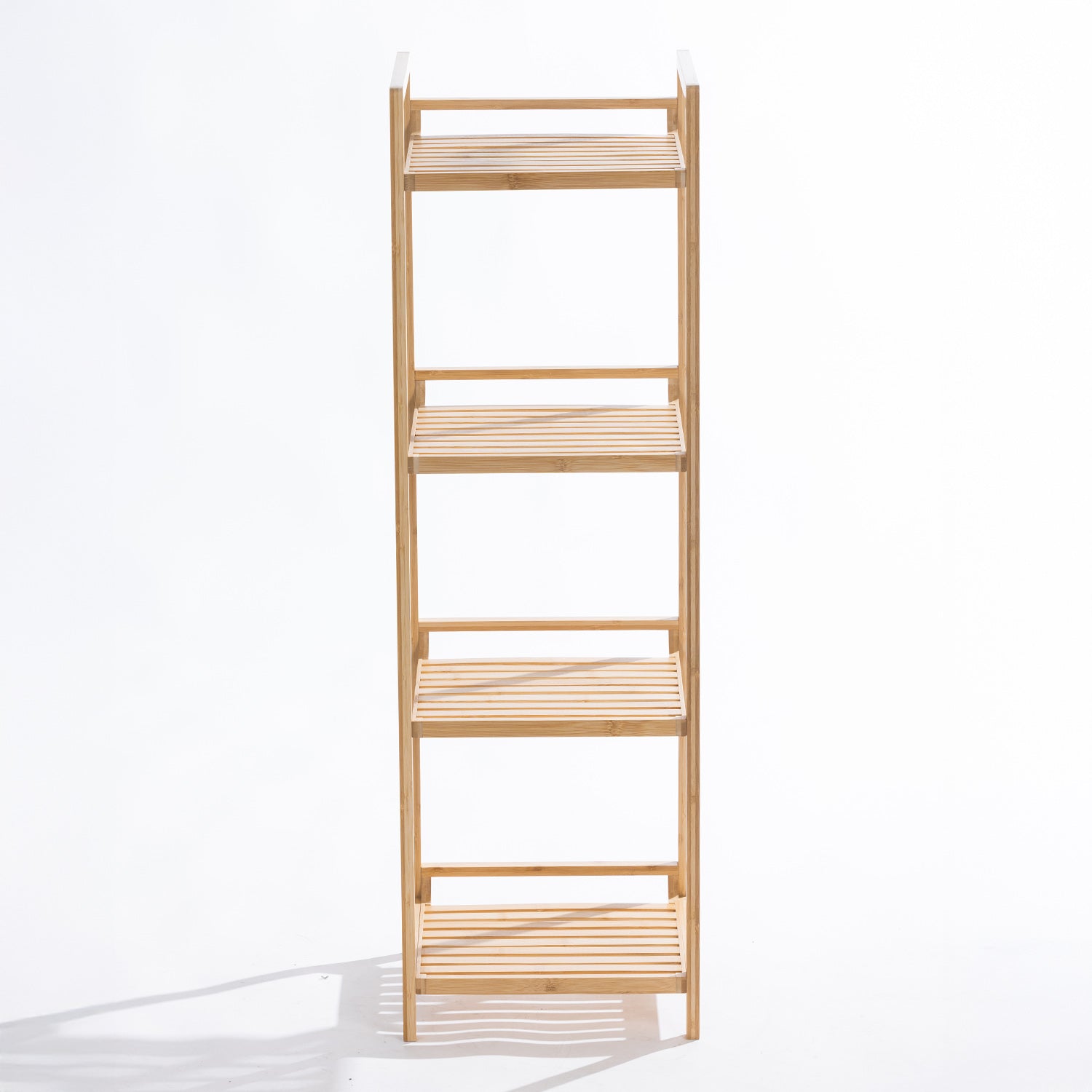 A freestanding four-tier bamboo shelving unit with open slatted shelves offers a simple, natural storage solution for bathrooms.