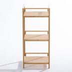 A freestanding three-tier bamboo shelving unit with open slatted shelves and a slim vertical design provides stylish, space-saving storage for bathrooms.