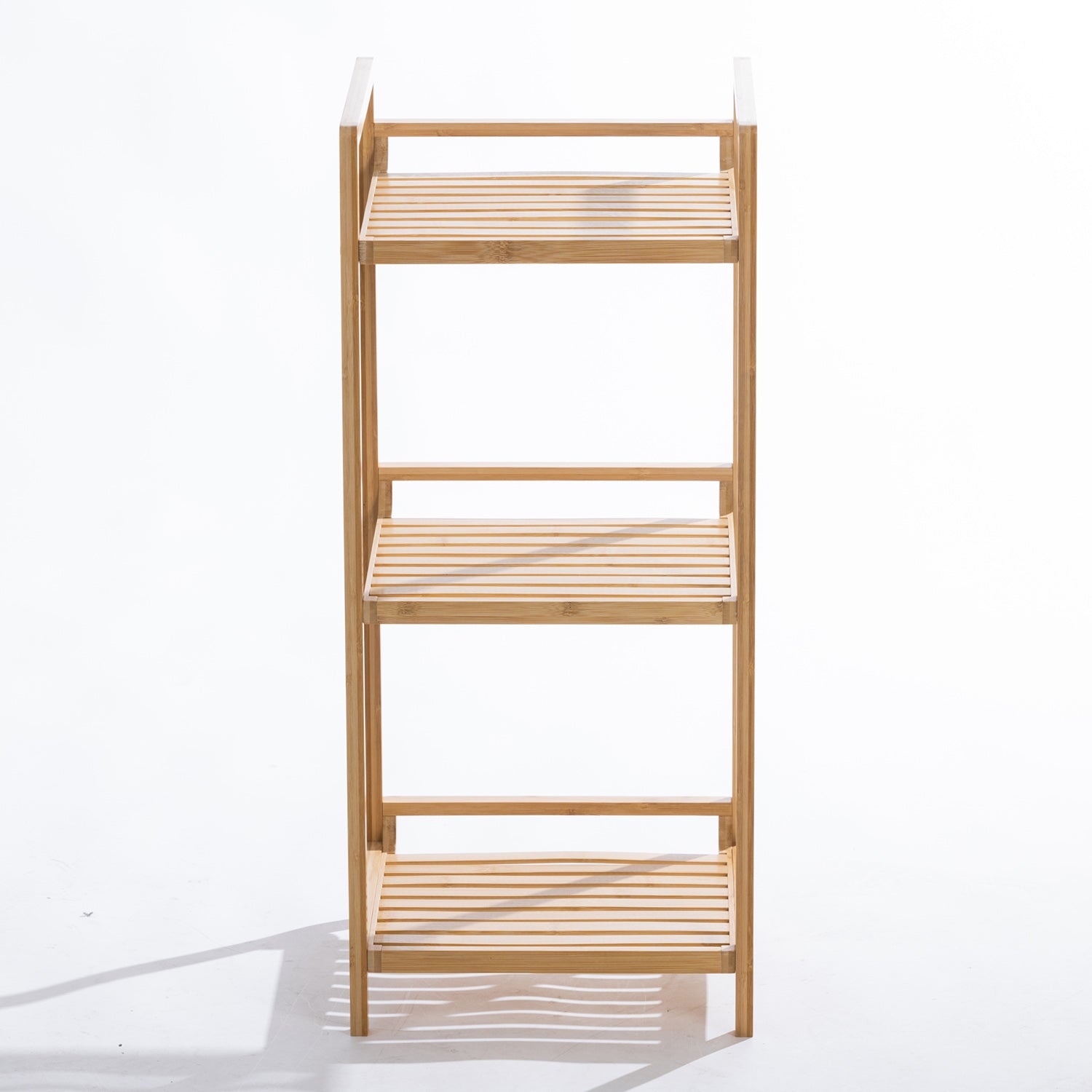 A freestanding three-tier bamboo shelving unit with open slatted shelves and a slim vertical design provides stylish, space-saving storage for bathrooms.