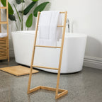 A freestanding bamboo towel ladder neatly displays fresh towels in a bright, contemporary bathroom, adding natural warmth and practical everyday storage.