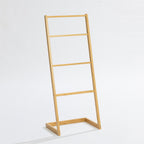 A freestanding bamboo towel ladder with four rails offers a simple, space-saving solution for hanging and drying towels while adding natural warmth to your bathroom.