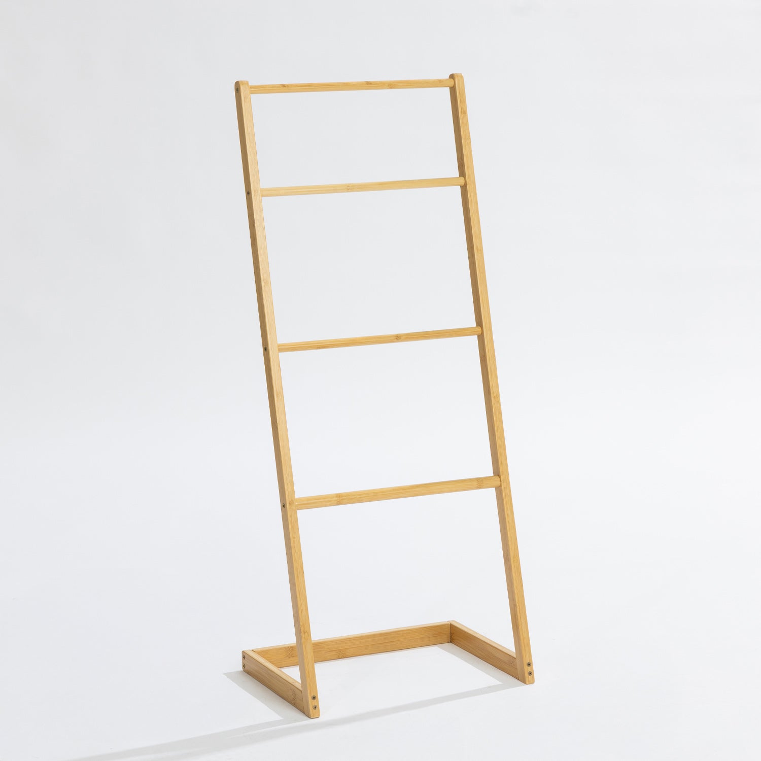 A freestanding bamboo towel ladder with four rails offers a simple, space-saving solution for hanging and drying towels while adding natural warmth to your bathroom.