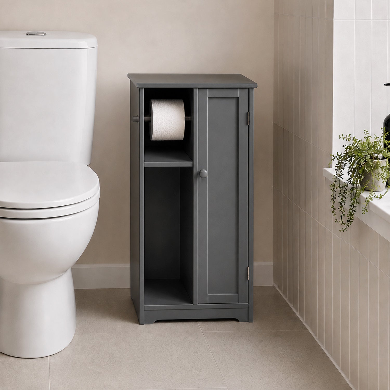 Grey toilet roll holder and cabinet with open shelving and enclosed cupboard placed beside a white toilet in a bathroom.