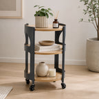 Solace Parker 3 Tier Trolley in black and natural styled with plants, books, decorative accessories and a candle in a modern living space.