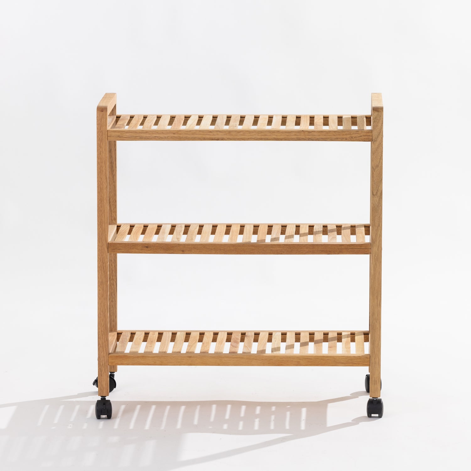 A three-tier wooden rolling shelf cart with a light natural oak finish and black caster wheels, photographed against a clean white studio background.