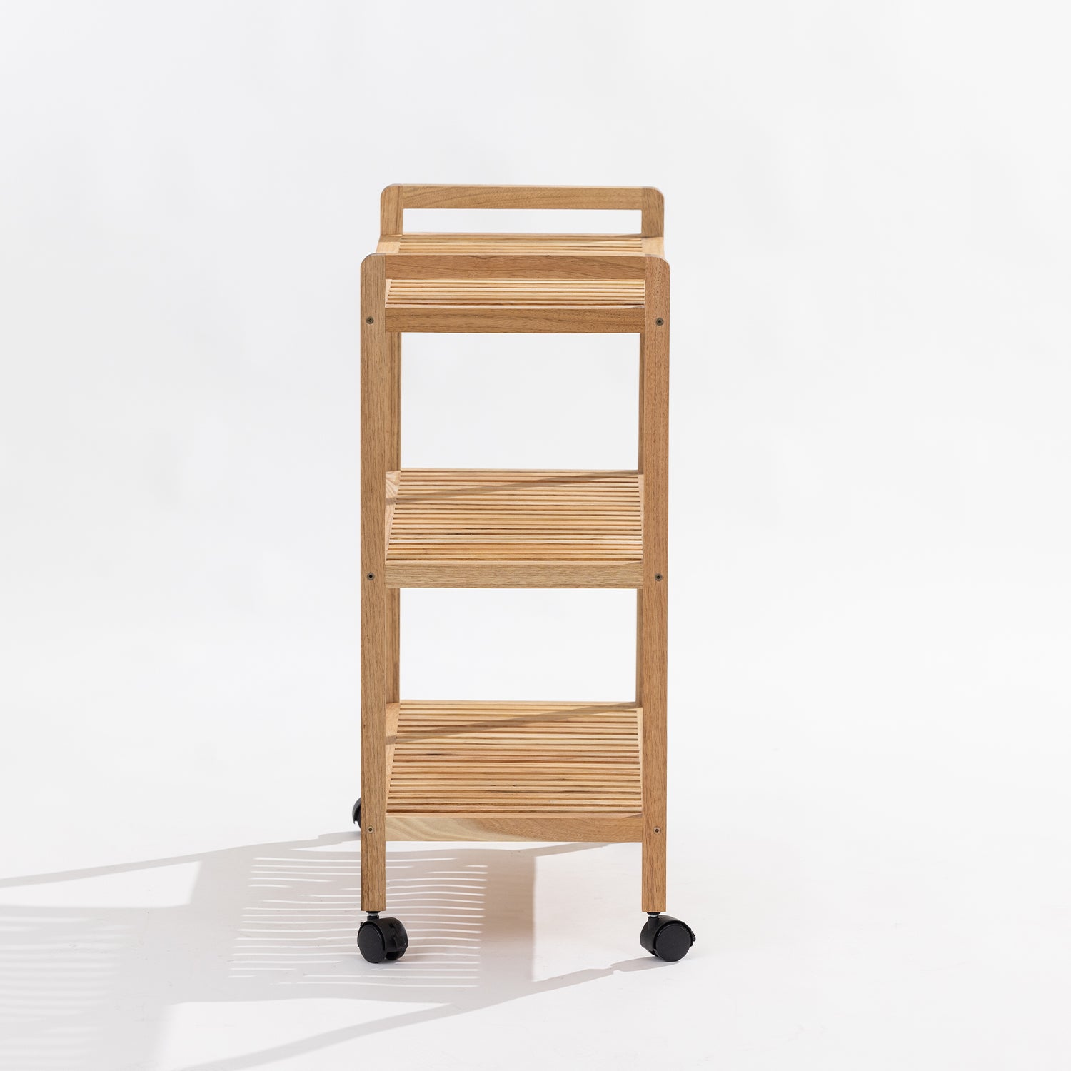 A three-tier wooden rolling cart with black caster wheels, shown against a clean white background with a soft shadow.