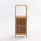 A tall, minimalist wooden storage cabinet with an open top shelf and a lower slatted door, shown against a plain white studio background.