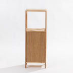 A minimalist two-tier wooden cabinet with an open upper shelf and a single lower door, crafted from light oak wood with a visible grain, set against a plain white background. Back View