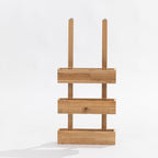A three-tier wooden over door storage shot in a studio setting front view. 