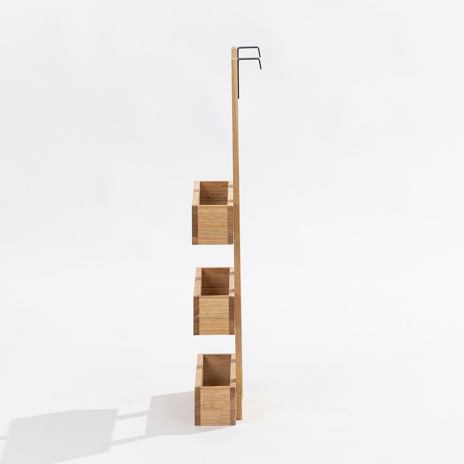 A three-tier wooden over door storage shot in a studio setting side view. 