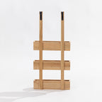 A three-tier wooden over door storage shot in a studio setting back view. 
